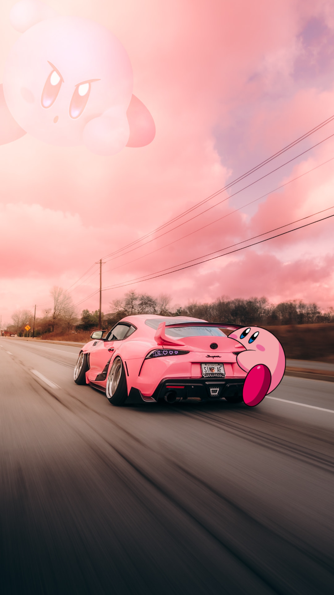 Pink modified Toyota Supra with two Kirby figures beneath pink clouds